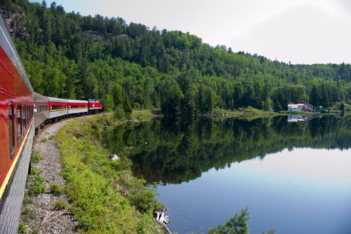 a train crossing a bridge over a body of water