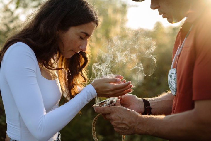 a woman holding a piece of cake